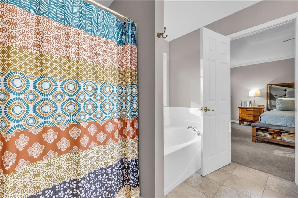 1670 Alcovy River Drive Dacula, GA 30019 - Photo 25 of 43 a bathroom with a bathtub and shower