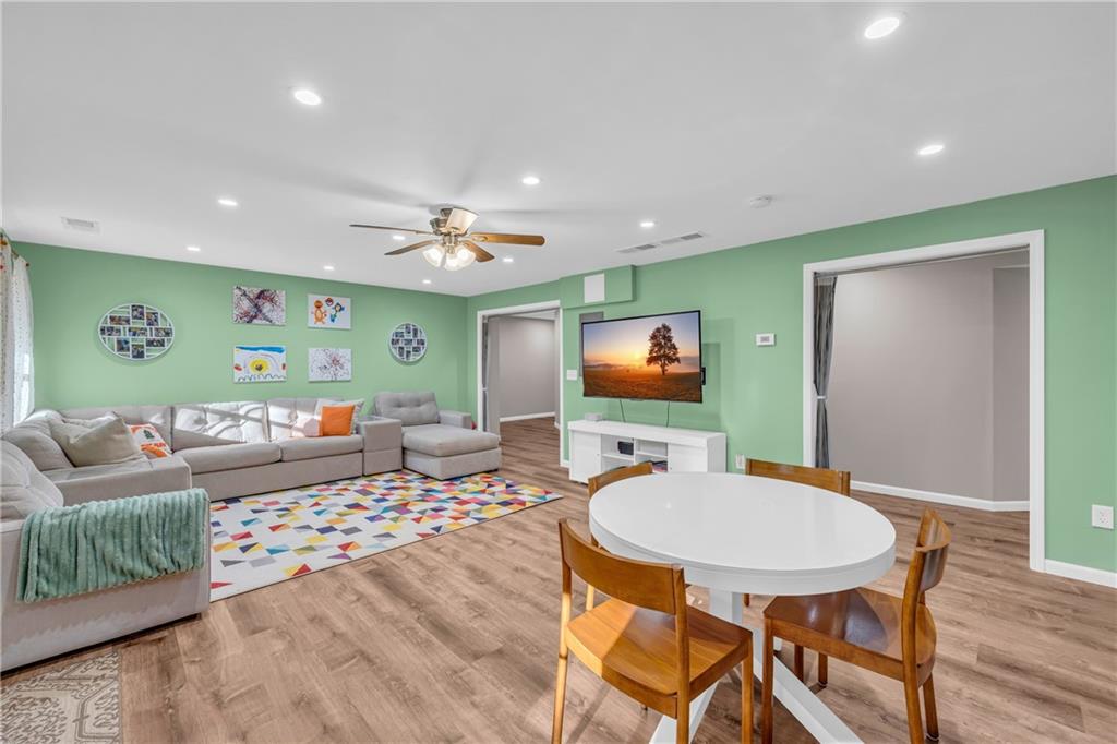 1670 Alcovy River Drive Dacula, GA 30019 - Photo 27 of 43 a living room with furniture and a flat screen tv