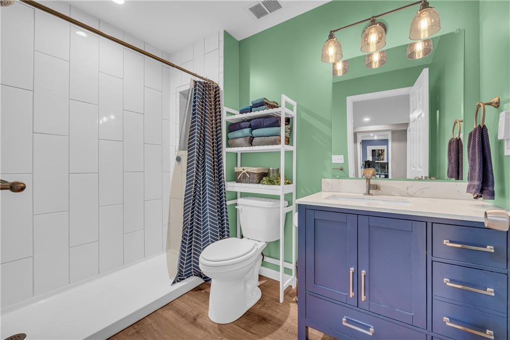 1670 Alcovy River Drive Dacula, GA 30019 - Photo 29 of 43 a bathroom with a toilet a sink and mirror