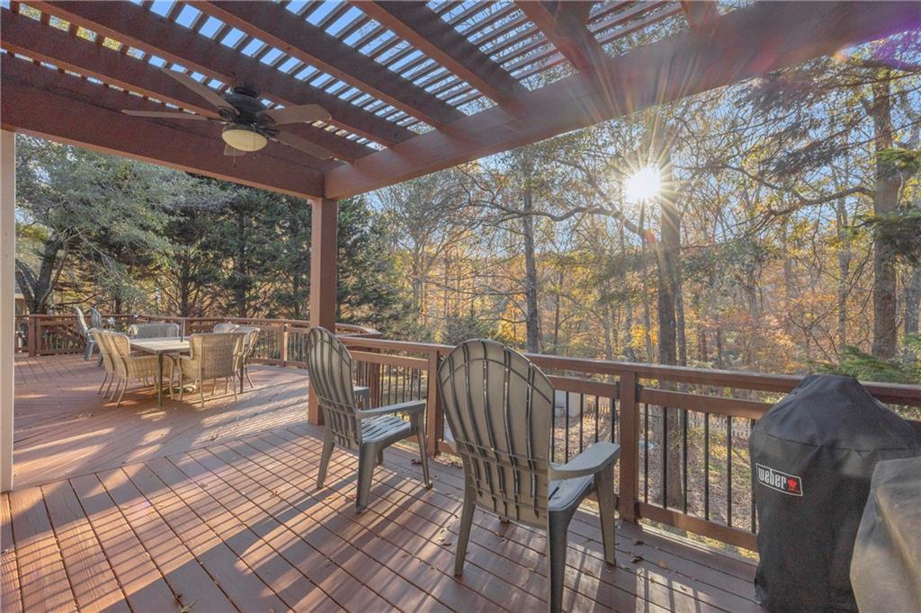 1670 Alcovy River Drive Dacula, GA 30019 - Photo 33 of 43 a view of a patio with table and chairs with wooden floor and fence