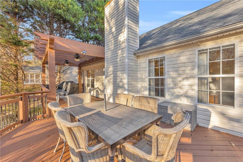1670 Alcovy River Drive Dacula, GA 30019 - Photo 34 of 43 a view of a patio with table and chairs with wooden floor and fence