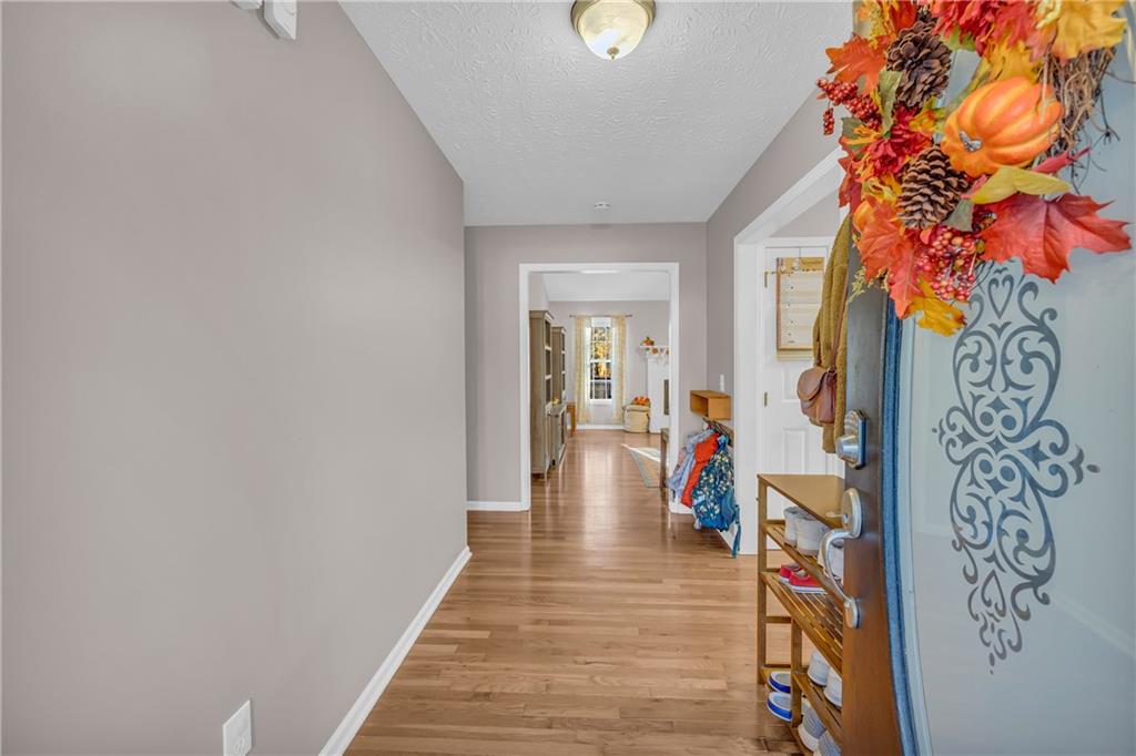 1670 Alcovy River Drive Dacula, GA 30019 - Photo 4 of 43 a hallway with wooden floor and a potted plant