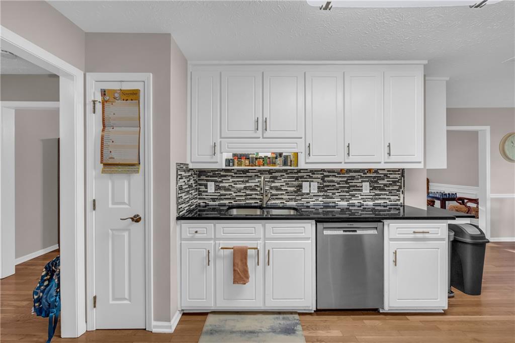 1670 Alcovy River Drive Dacula, GA 30019 - Photo 6 of 43 a kitchen with granite countertop cabinets and white appliances
