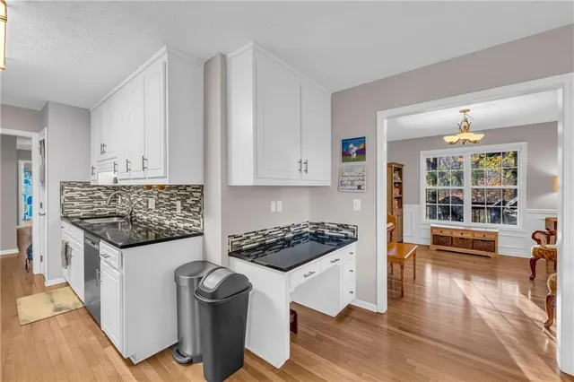 a dining room with furniture and a window