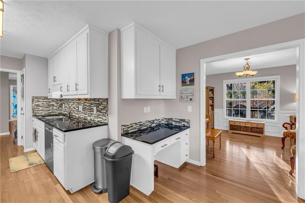 1670 Alcovy River Drive Dacula, GA 30019 - Photo 8 of 43 a kitchen with granite countertop a stove and a wooden floors