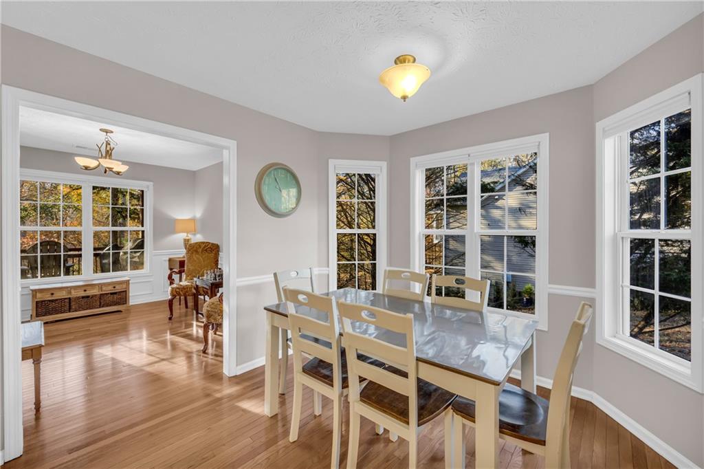 1670 Alcovy River Drive Dacula, GA 30019 - Photo 9 of 43 a view of a dining room with furniture and wooden floor