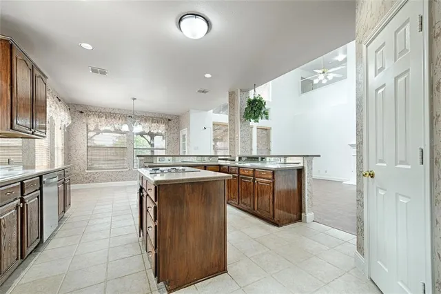 a kitchen with stainless steel appliances granite countertop a stove and a refrigerator