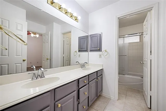 a bathroom with a sink double vanity and a mirror