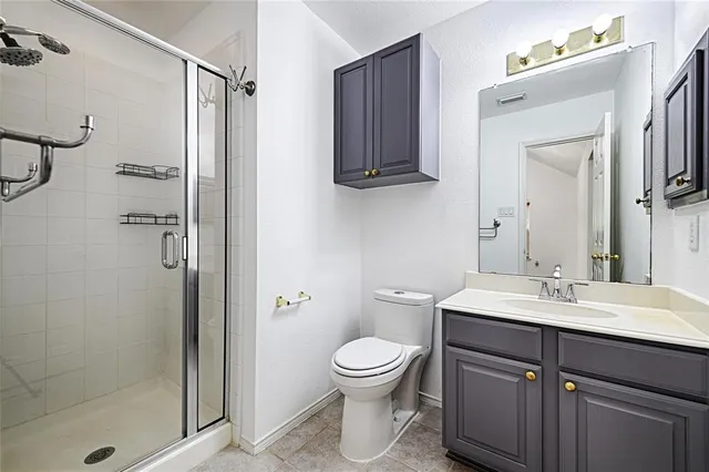 a bathroom with a toilet sink a shower and a mirror