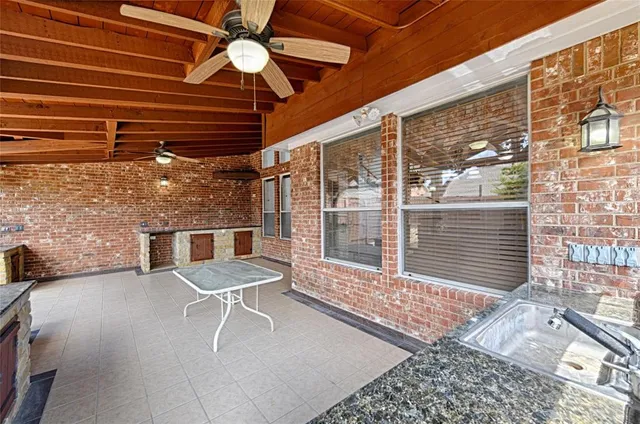 a view of a porch with a table and chairs