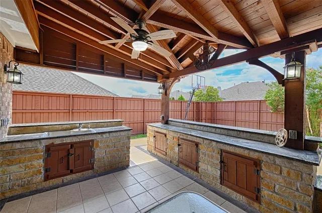 a kitchen with stainless steel appliances granite countertop a sink and wooden cabinets