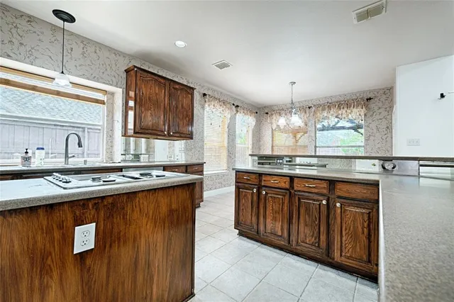 a kitchen with stainless steel appliances granite countertop a sink stove and cabinets