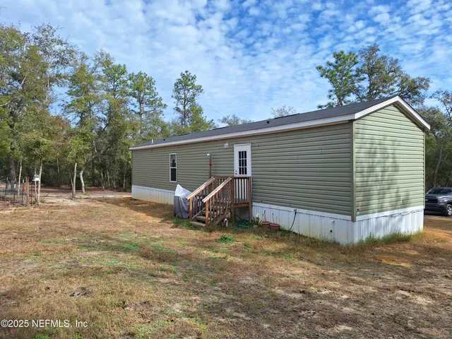 a view of a house with a backyard space and garden