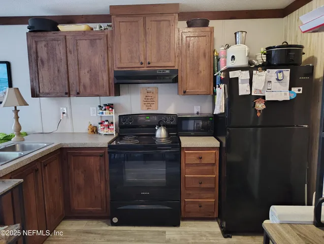a kitchen with stainless steel appliances granite countertop a refrigerator and a stove