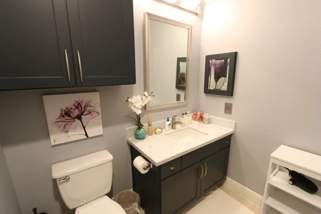 a bathroom with a toilet sink and mirror