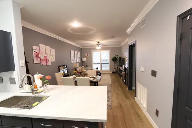 a living room with furniture a wooden floor and a large window