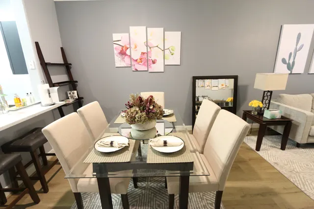 a view of a dining room with furniture and wooden floor