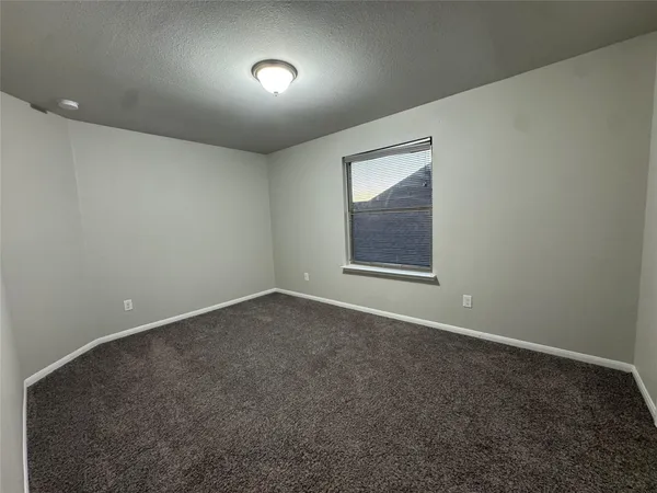 an empty room with a empty space and windows