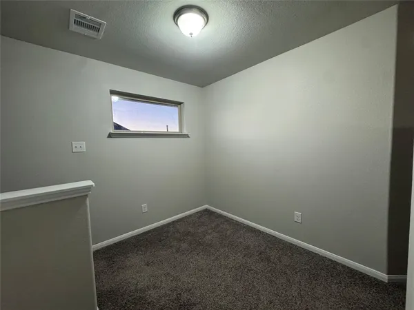 an empty room with closet area