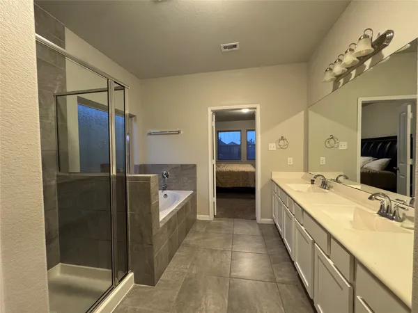 a bedroom with a bed and a night stand