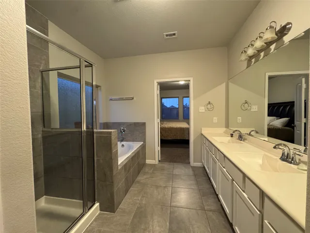 a bedroom with a bed and a night stand