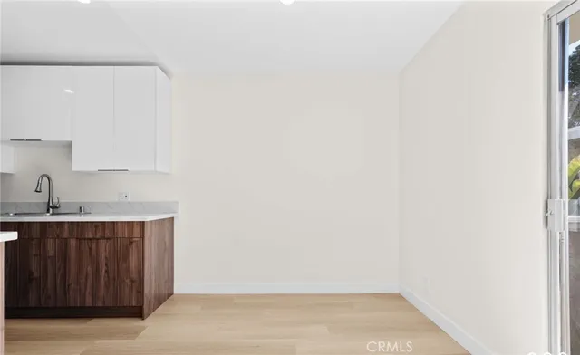 a room with a sink and cabinets