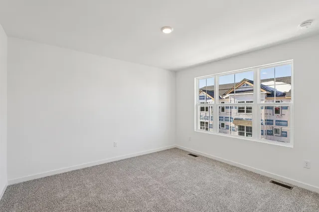 a view of an empty room and closet area