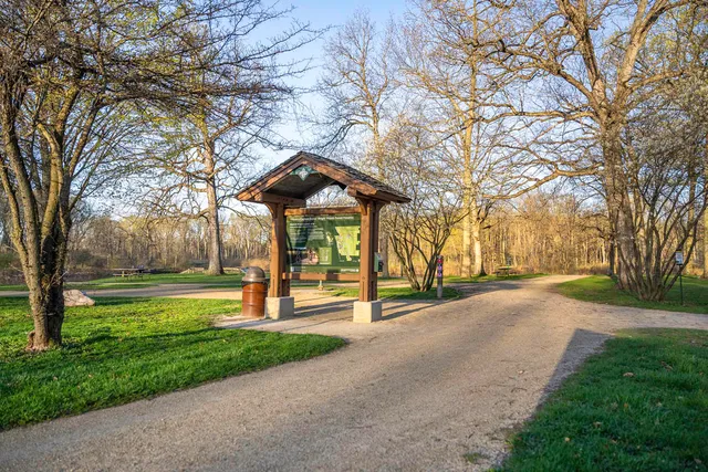 a sign board on the side of a street