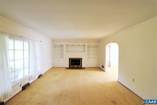 150 Bibb Store Road Louisa, VA 23093 - Photo 3 of 25 an empty room with a fireplace and a window