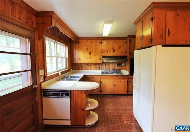 150 Bibb Store Road Louisa, VA 23093 - Photo 9 of 25 a kitchen with stainless steel appliances a refrigerator a sink a stove and white cabinets