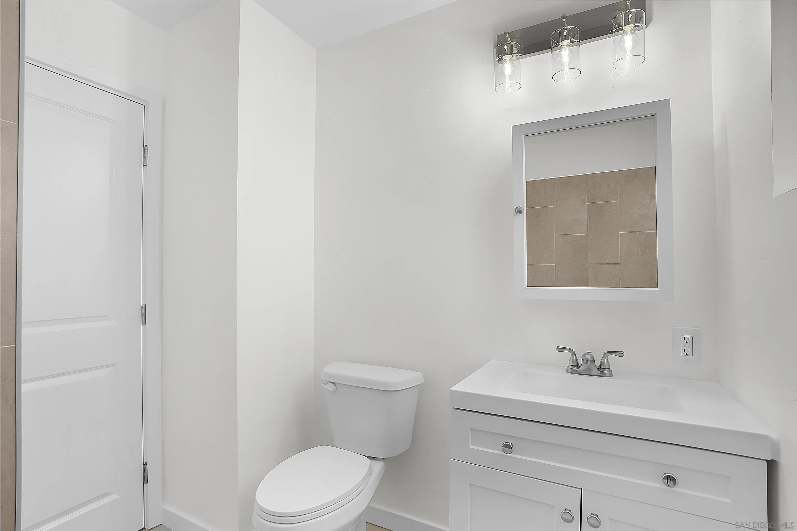 620 Elm Avenue Chula Vista, CA 91910 - Photo 13 of 30 a bathroom with a toilet a sink and mirror