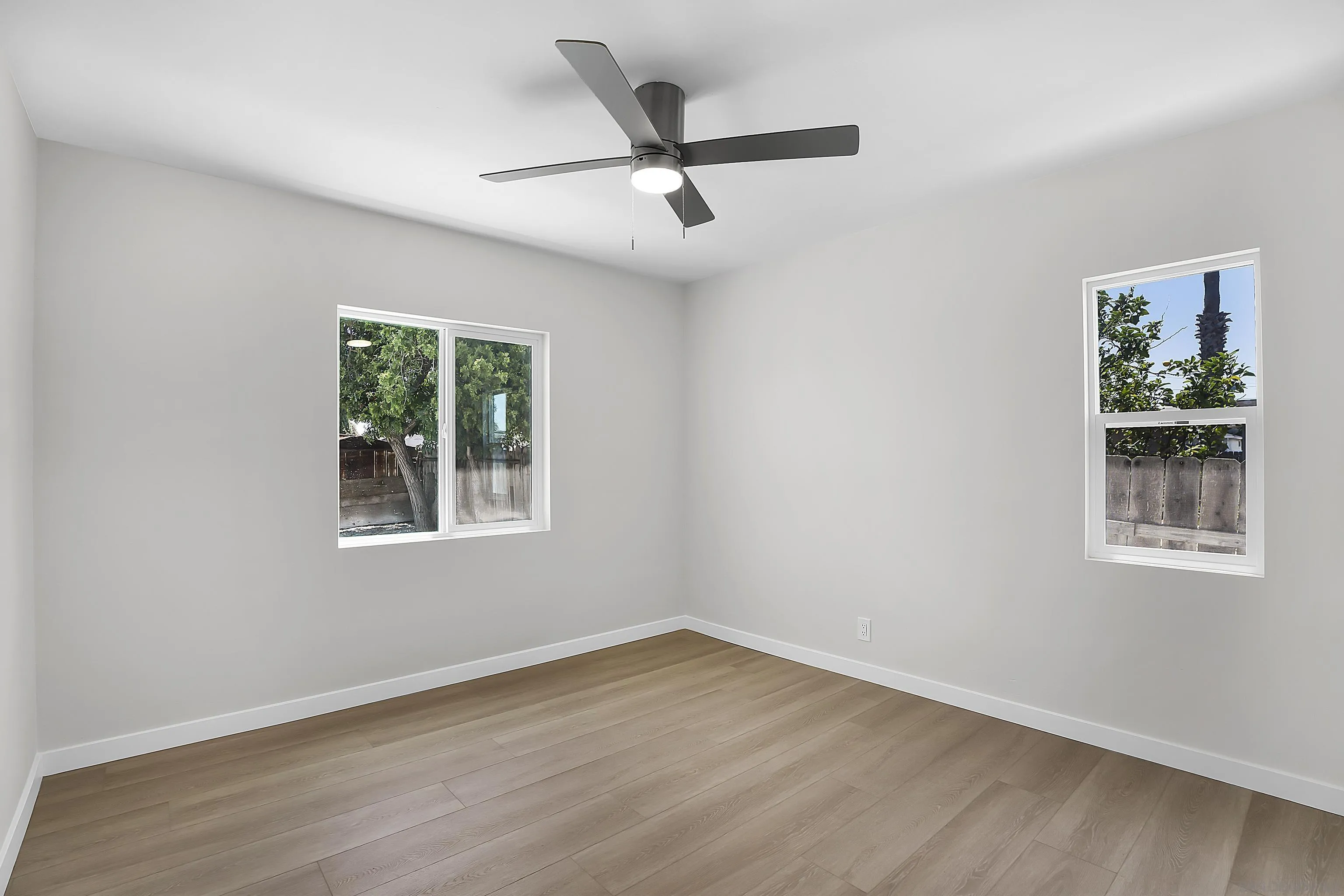620 Elm Avenue Chula Vista, CA 91910 - Photo 9 of 30 an empty room with wooden floor ceiling fan and windows
