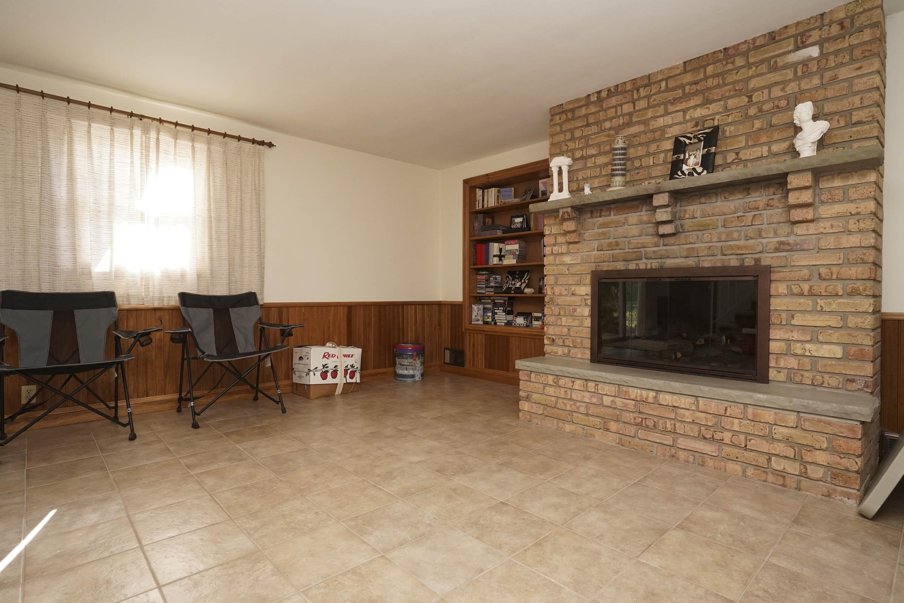 2707 Spring Creek Road Rockford, IL 61107 - Photo 25 of 44 a living room with furniture and a fireplace