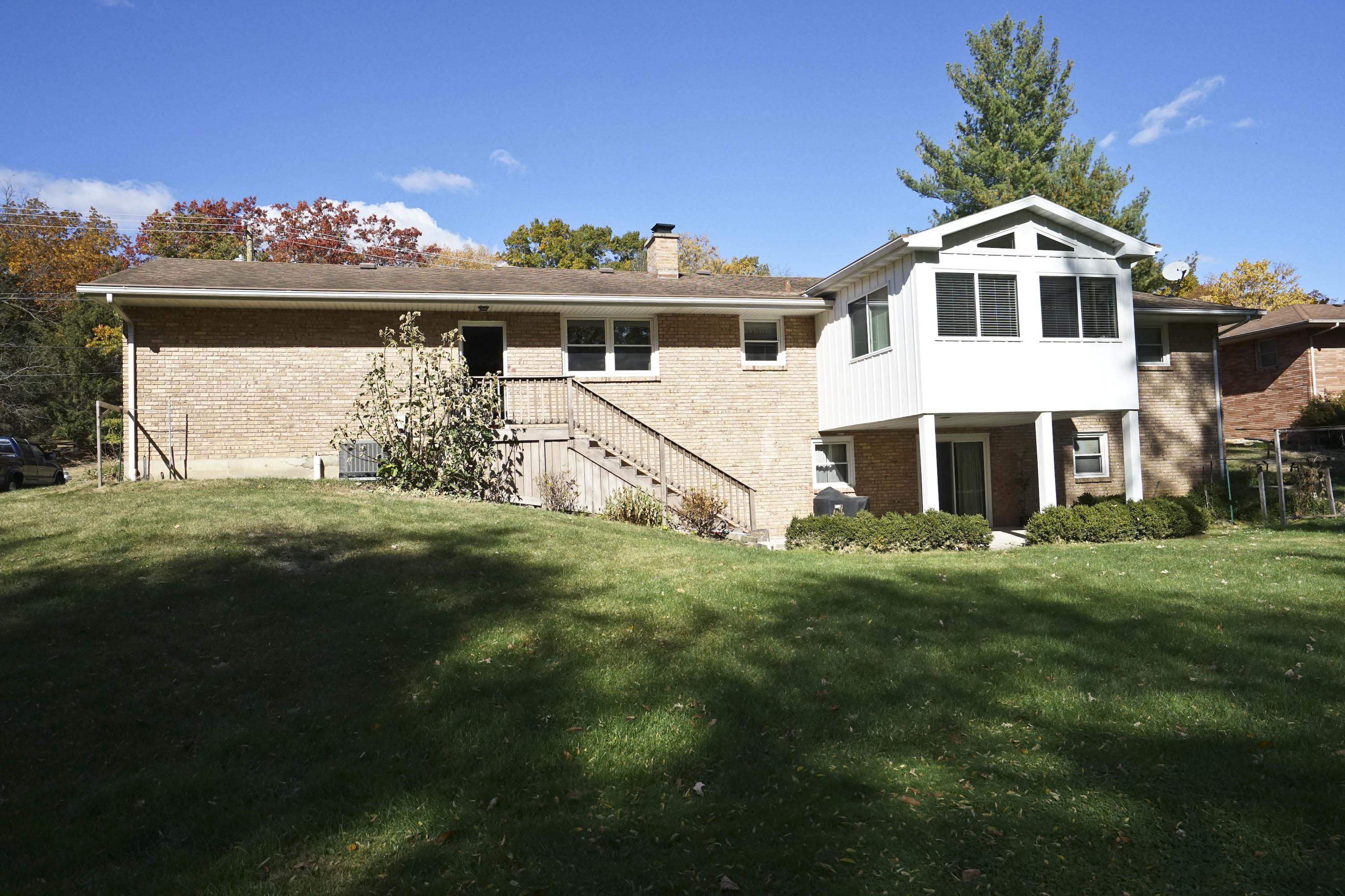 2707 Spring Creek Road Rockford, IL 61107 - Photo 35 of 44 a front view of a house with a garden