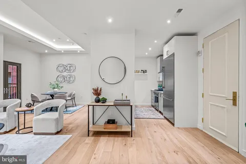 a living room with furniture and a lamp