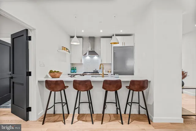 a kitchen with a sink and a stove top oven