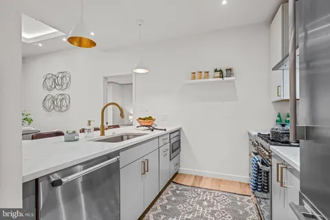 a large white bathroom with a sink and a mirror