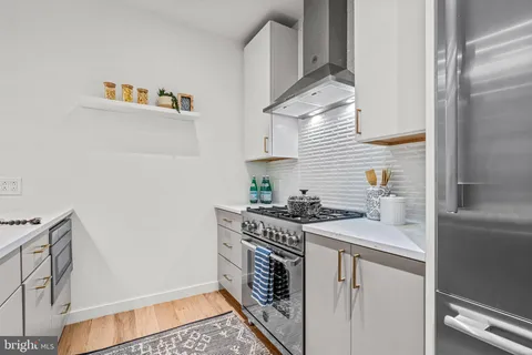 a kitchen with stainless steel appliances kitchen island a refrigerator sink and stove