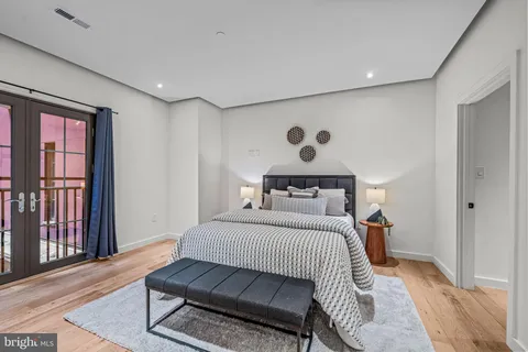 a bedroom with a large bed and a large window