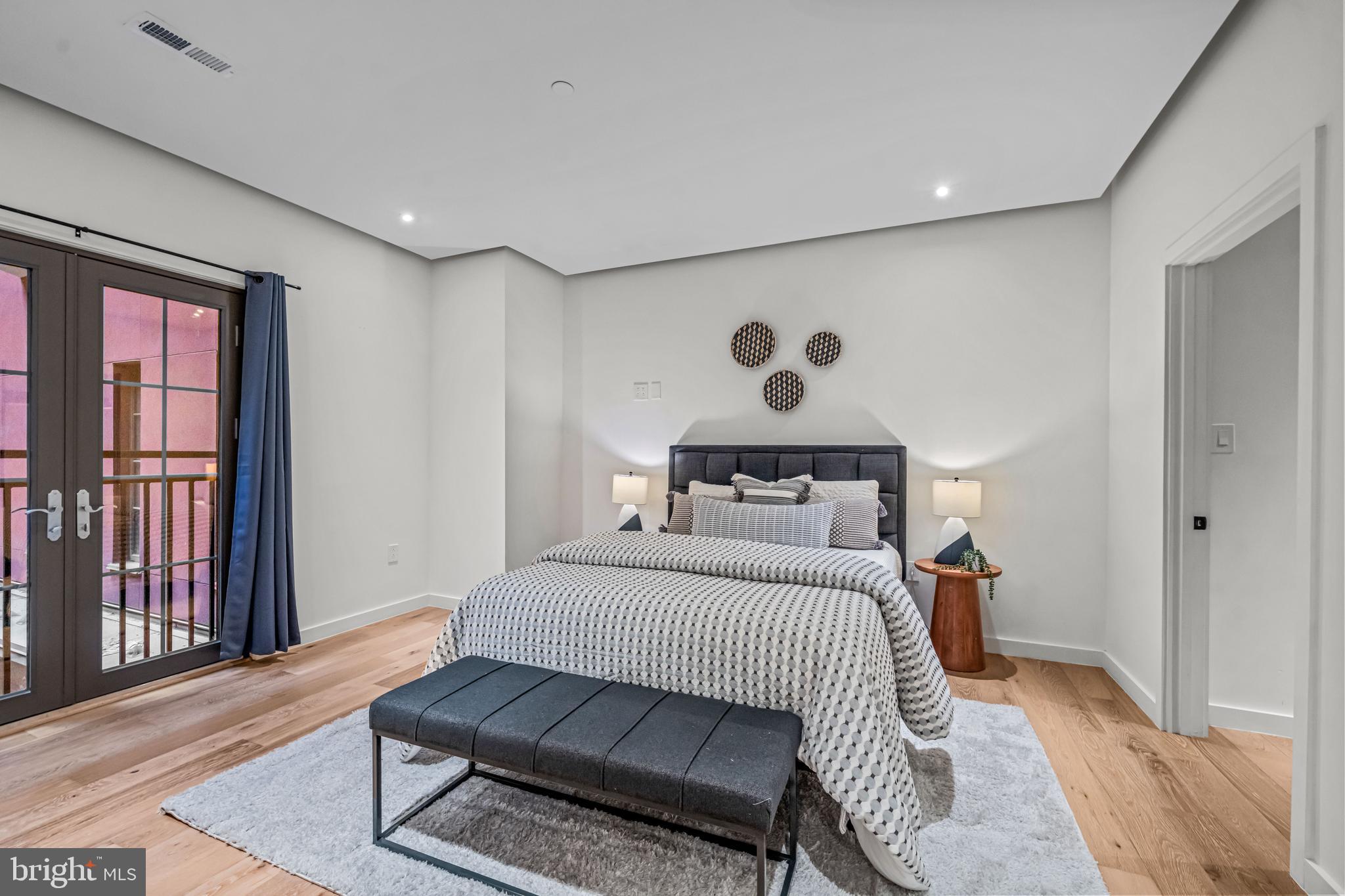 219 South 18th Street, Unit 309 Philadelphia, PA 19103 - Photo 26 of 44 a bedroom with a bed and wooden floor