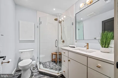 a bathroom with a shower and a sink