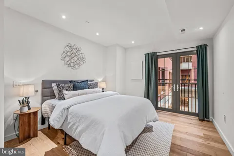 a bedroom with a large bed and a chandelier