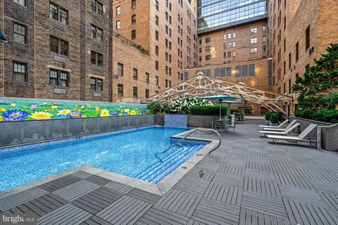 a view of a patio with couches and table and chairs with wooden floor