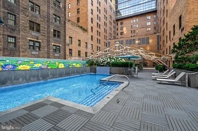 a view of a patio with couches and table and chairs with wooden floor