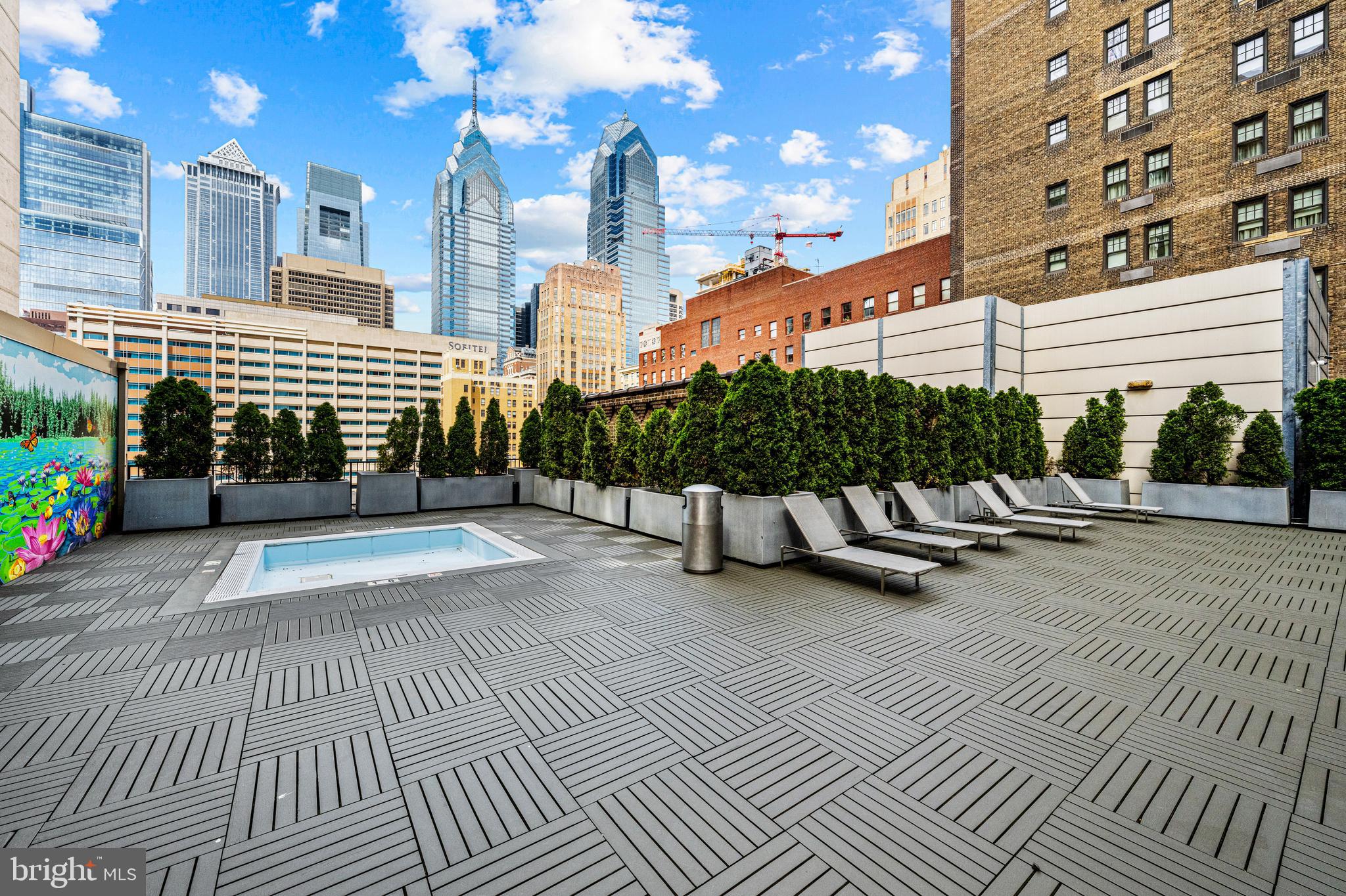 219 South 18th Street, Unit 309 Philadelphia, PA 19103 - Photo 38 of 44 a view of a patio with couches and table and chairs with wooden floor