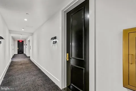 a kitchen with stainless steel appliances granite countertop a refrigerator a stove and a wooden floor