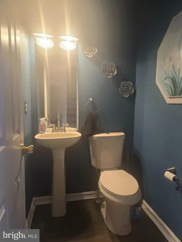 a bathroom with a toilet a sink and a shower