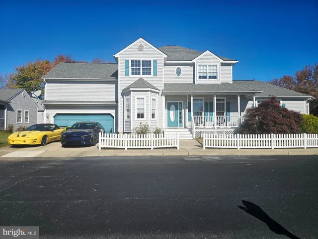 a front view of a house with swimming pool and porch