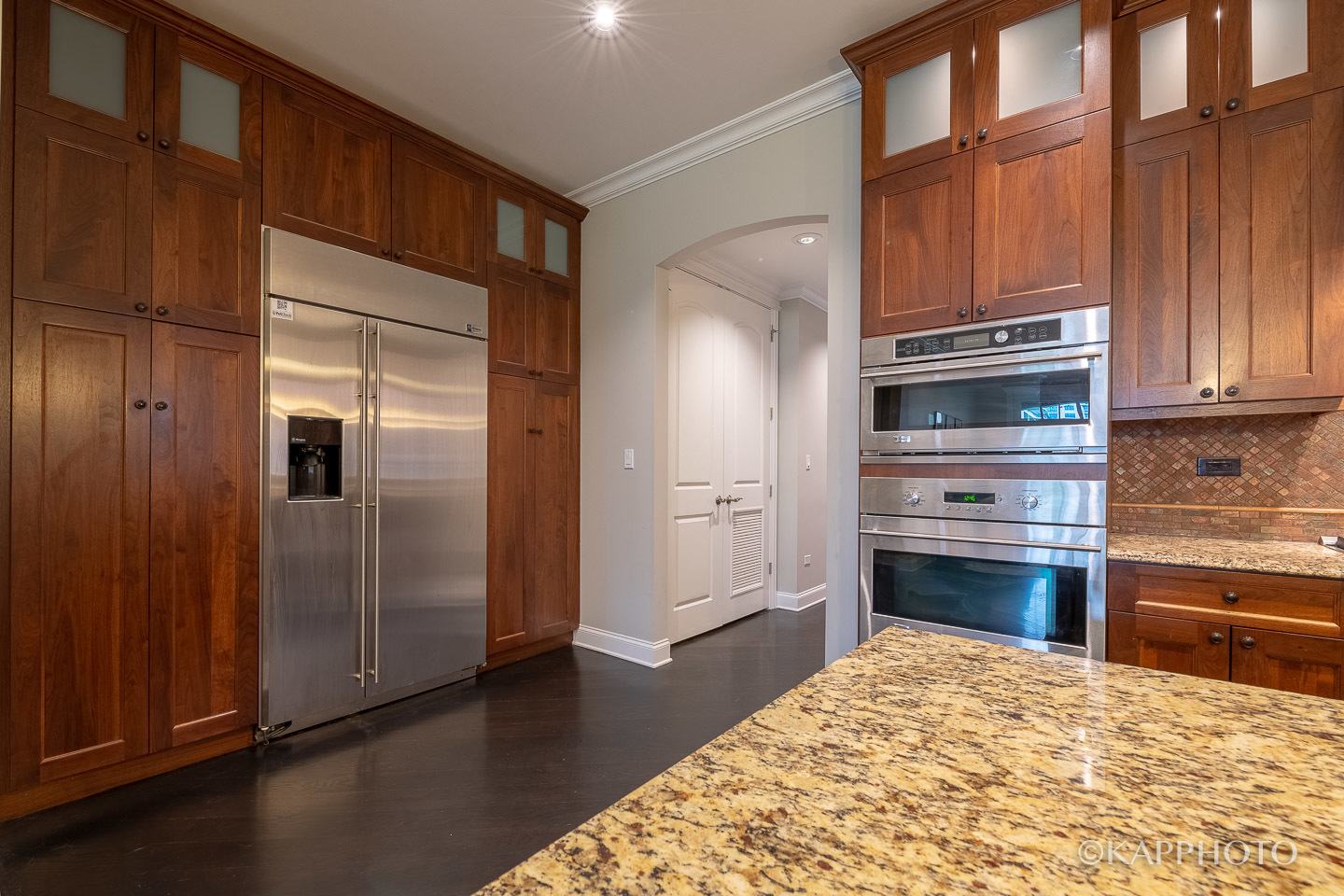 106 South Sangamon Street, Unit 3N Chicago, IL 60607 - Photo 12 of 27 a kitchen with granite countertop wooden cabinets and stainless steel appliances