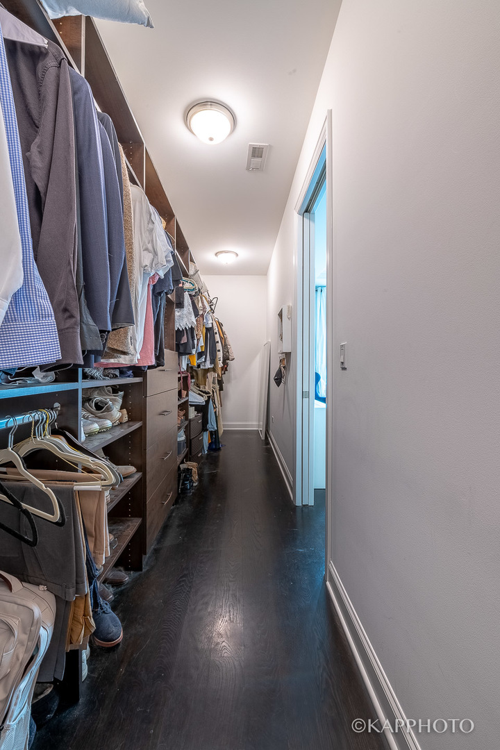 106 South Sangamon Street, Unit 3N Chicago, IL 60607 - Photo 16 of 27 a view of walk in closet with clothes and shoes